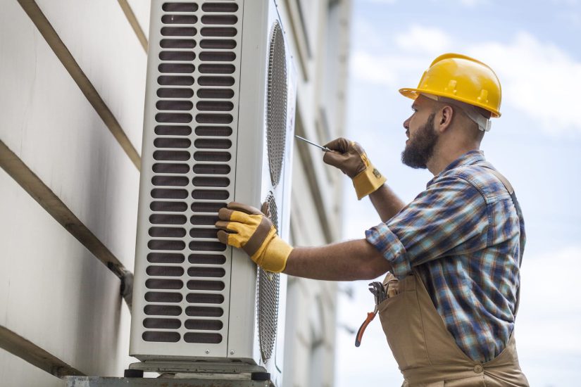 Worker Fixing An AC Unit