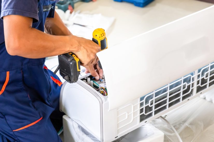 Photo of a man installing air conditioner